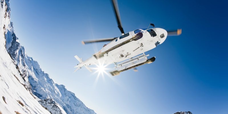 Heli Skiing Helicopter is landing on a ski slope in Gressoney Ski Resort, Aosta, Italy.