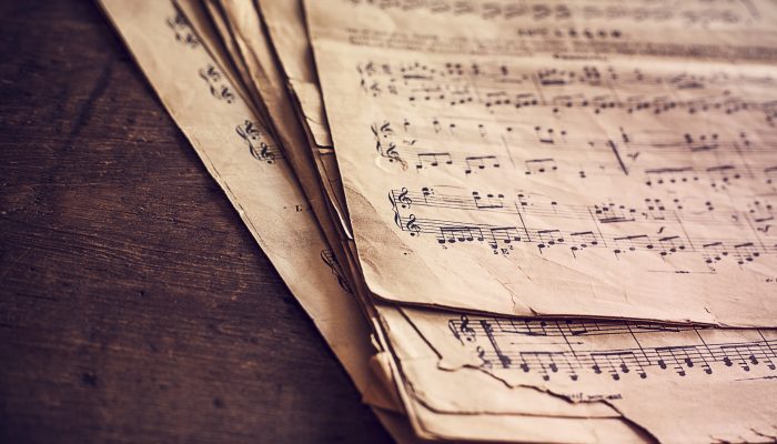 Music sheets on wooden background