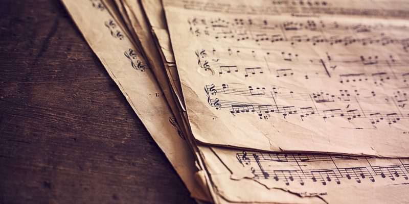 Music sheets on wooden background