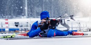 Biathlon training during winter blizzard.