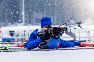 Biathlon training during winter blizzard.