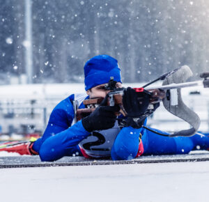 Biathlon training during winter blizzard.