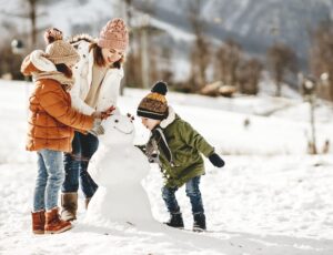 happy family mother and children daughter and son having fun on winter walk