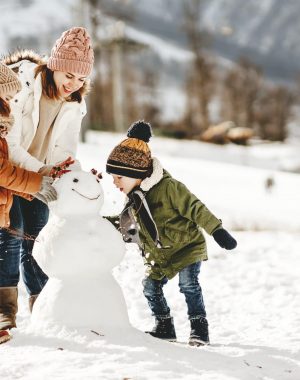 happy family mother and children daughter and son having fun on winter walk