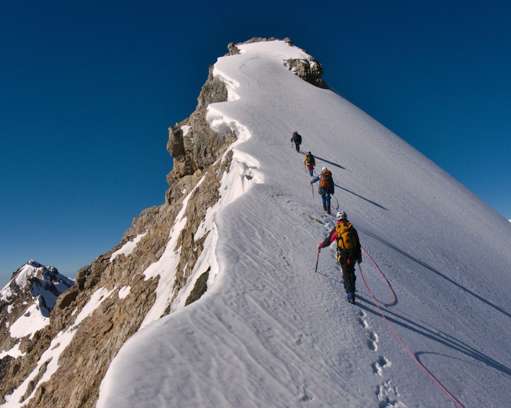 Tied,Climbers,Climbing,Mountain,With,Snow,Field,Tied,With,A