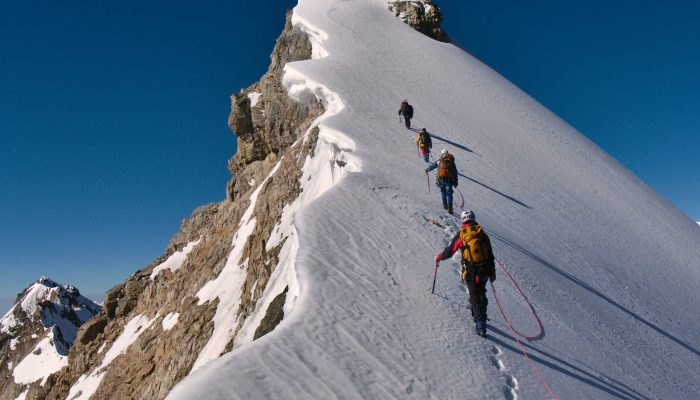 Tied,Climbers,Climbing,Mountain,With,Snow,Field,Tied,With,A