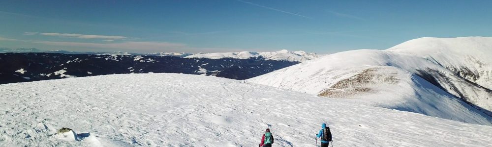 A,Drone,Shot,Of,A,Couple,Wearing,Snow,Shoes,Hiking