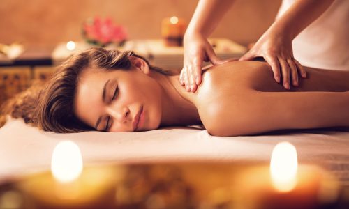Young woman relaxing during back massage at the spa.